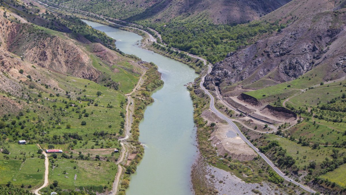 Stunning aerial view of the Euphrates River winding through Palu, Elazığ, Türkiye, showcasing lush green landscapes and rugged mountains.