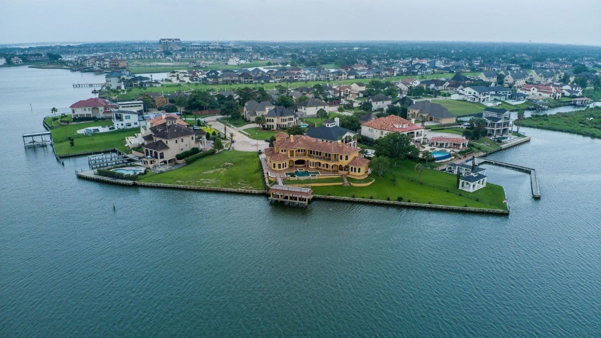 Stunning aerial shot of luxury homes by the water in Houston, Texas.