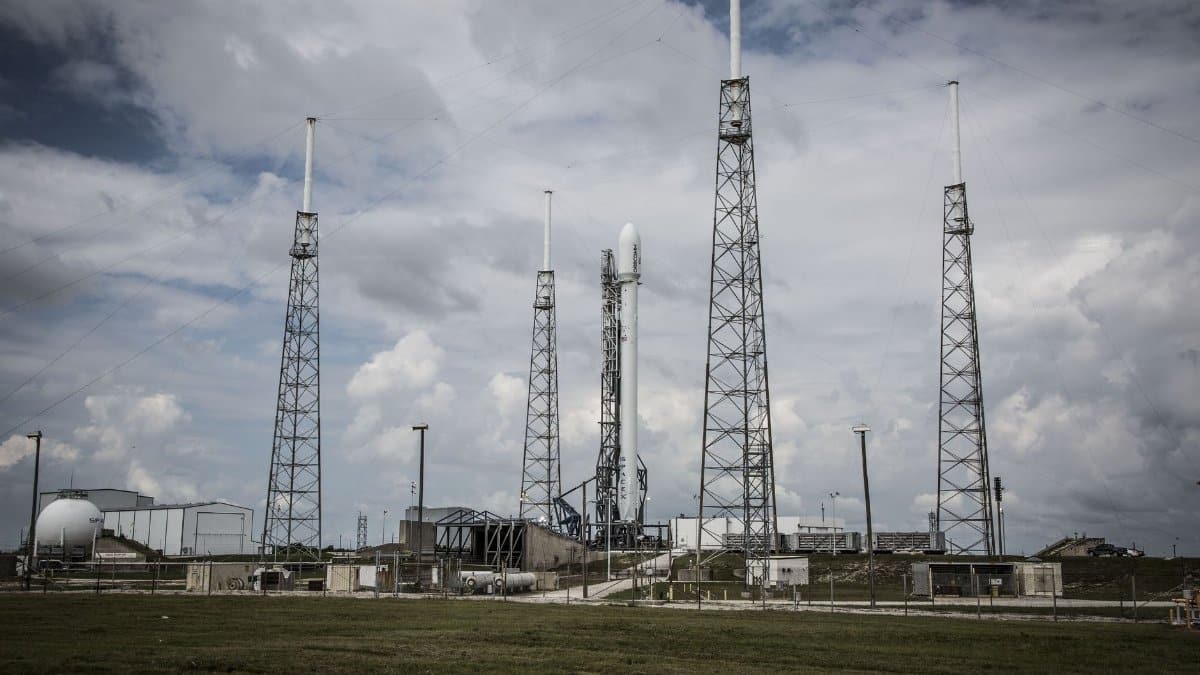 Industrial rocket launch pad with tall towers under a cloudy sky, perfect for technology and energy themes.