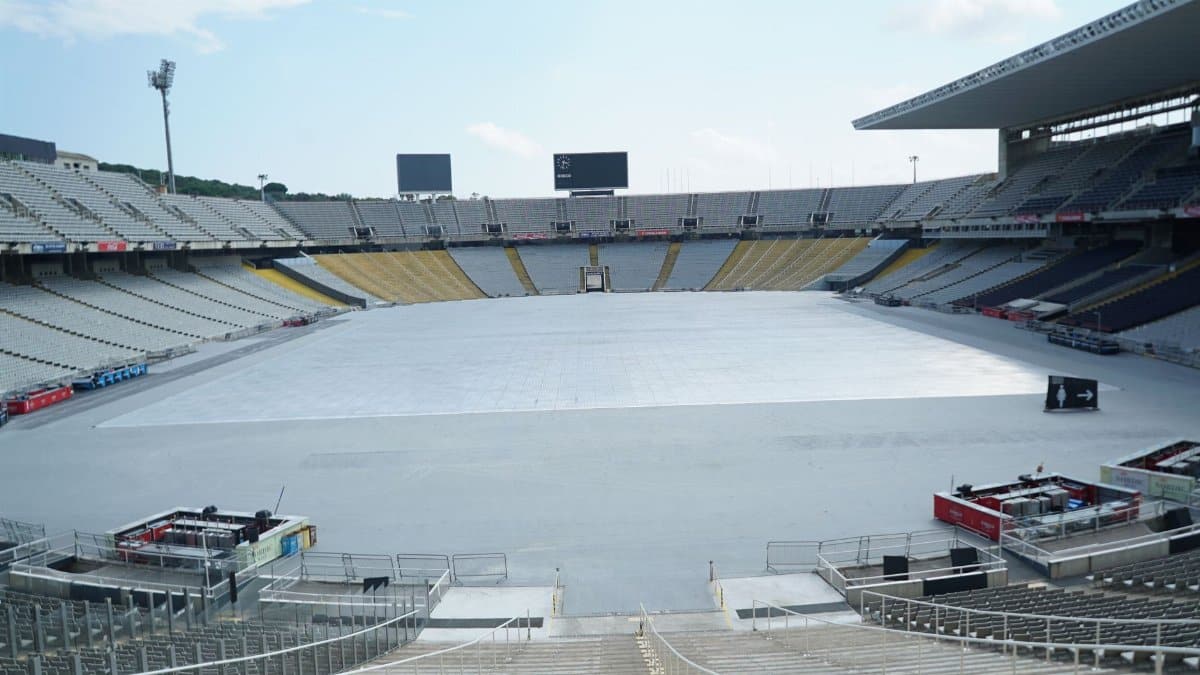 Panoramic view of an empty Olympic stadium in Barcelona with clear blue sky.