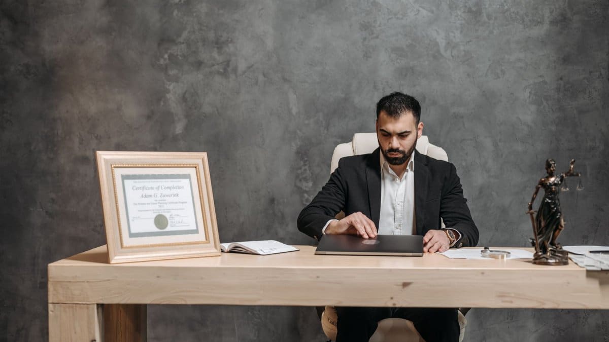 A bearded lawyer working at his office desk, showing professionalism and expertise.