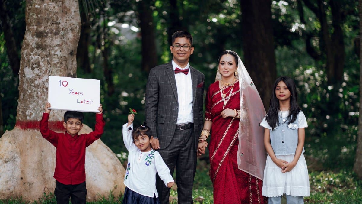 A family portrait with elegant traditional attire celebrating a 10-year anniversary outdoors.
