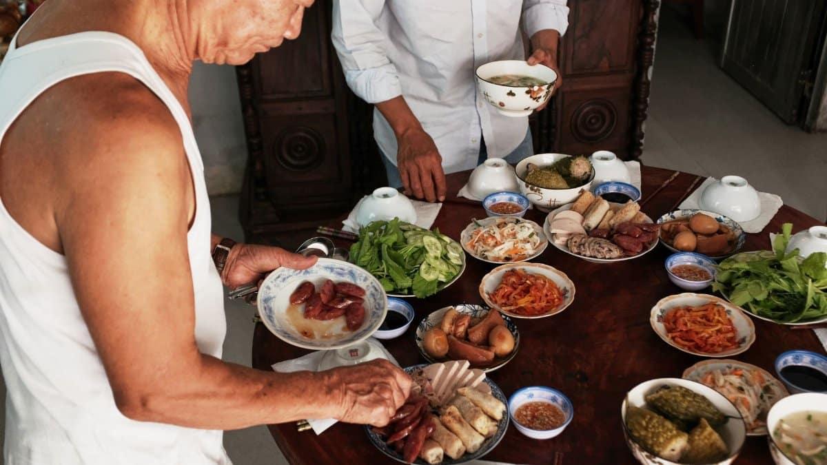 A vibrant scene of traditional Vietnamese cuisine being prepared for a family meal in Bến Tre, Vietnam.