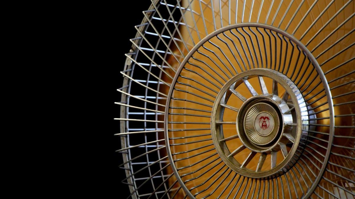 A detailed close-up of a vintage electric fan showcasing its intricate metal blades and design.