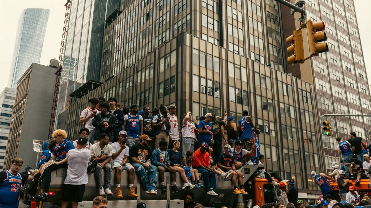 A lively gathering of people in New York City celebrating a sports event outdoors.