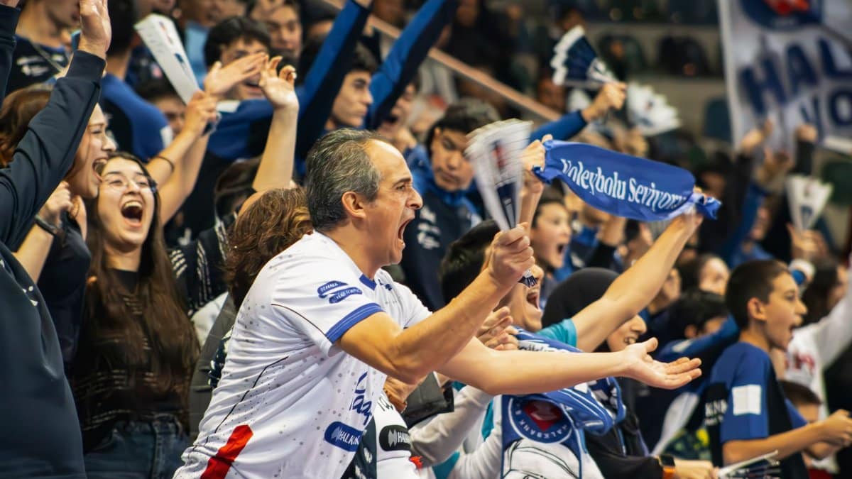 A vibrant crowd cheers enthusiastically at a sports event in Ankara, Türkiye, capturing the energy and excitement.