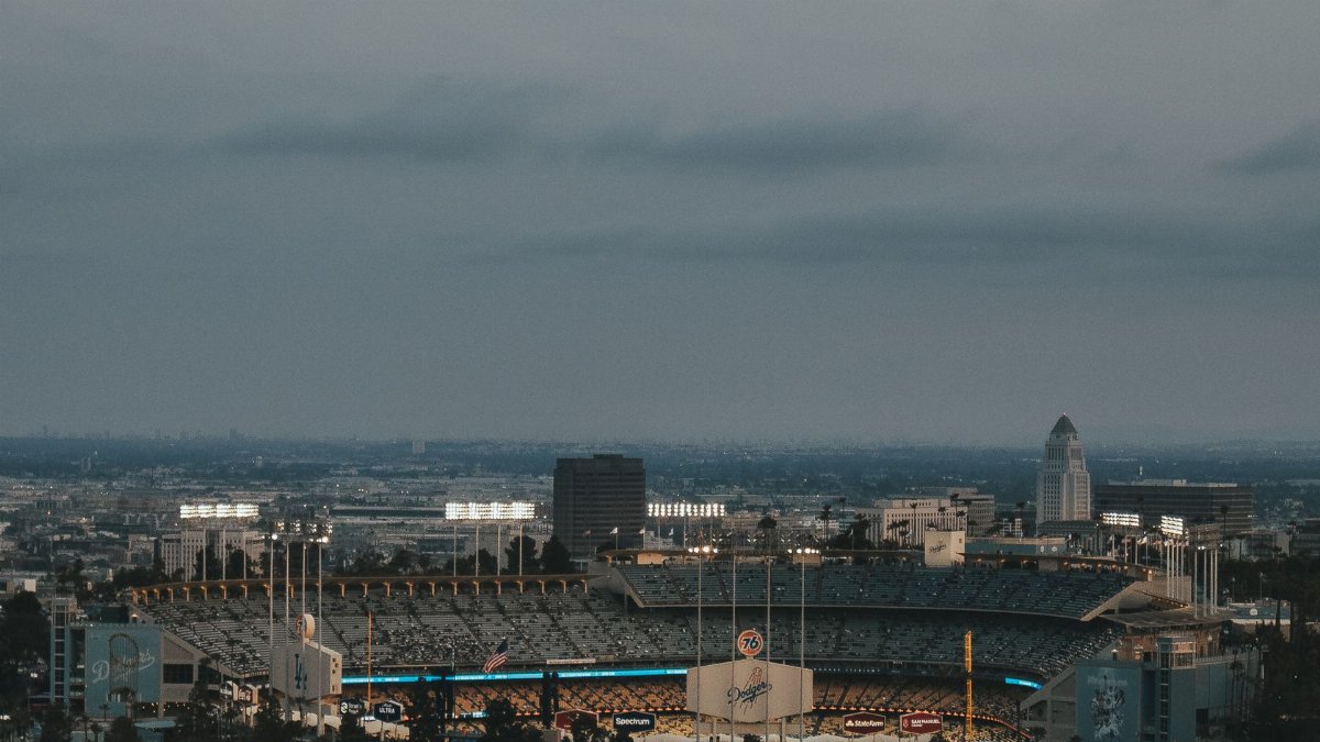 A stunning aerial view of Dodger Stadium in Los Angeles at dusk, showcasing the vibrant urban landscape.
