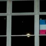A photo of a Trans Rights Matter sign displayed in a window, emphasizing LGBTQ awareness.