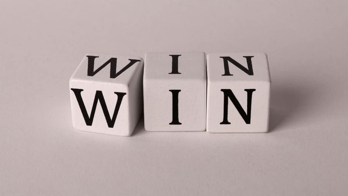 White cubes with the word 'WIN' against a light background symbolizing success and achievement.