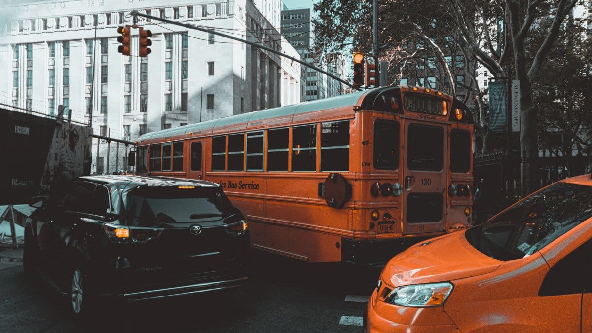 Busy New York City street with traffic including a classic yellow school bus.