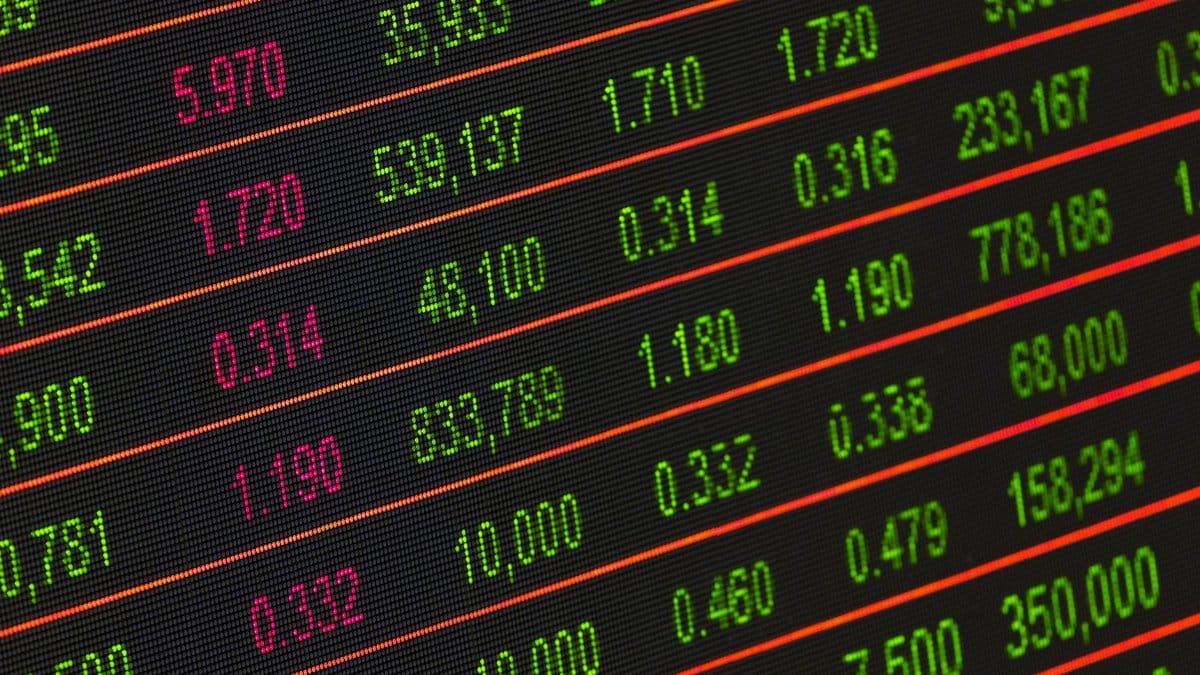 Close-up of a digital stock market data display showing colorful financial numbers and trends.