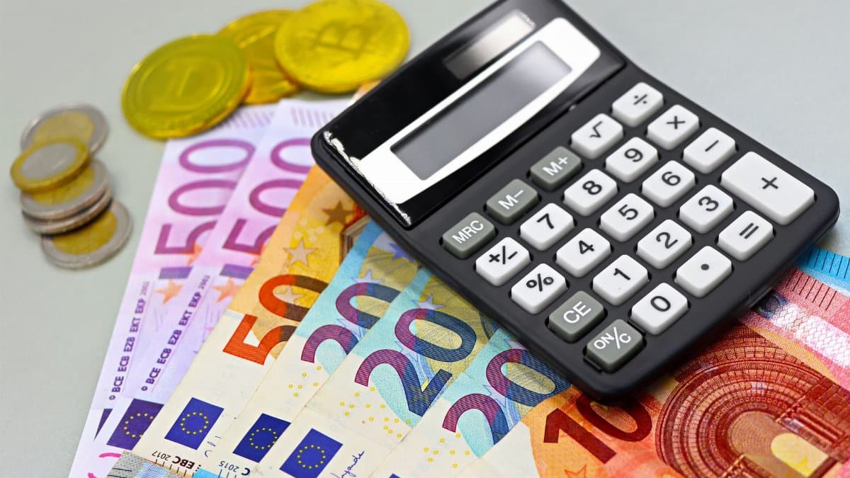 Image of euro banknotes, coins, and a calculator for financial planning. Perfect for finance themes.