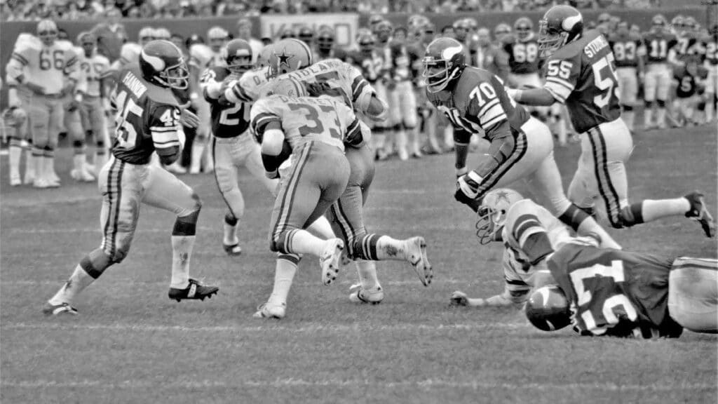 A vintage capture of athletes competing in a high-energy football game.