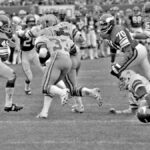 A vintage capture of athletes competing in a high-energy football game.