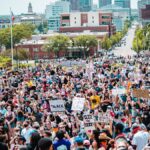 Large crowd gathering for Black Lives Matter protest in Des Moines city center, advocating for social justice.