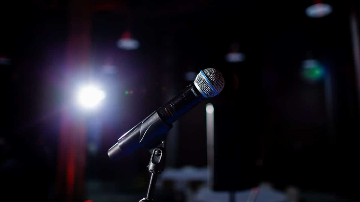 Microphone on a stage with spotlight, perfect for performance and public speaking themes.