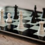 Close-up of chess game on a tablet featuring white and black pieces, emphasizing strategy and technology.