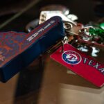 Detailed shot of Texas Rangers memorabilia keychains on a glass surface, capturing sports enthusiasm.