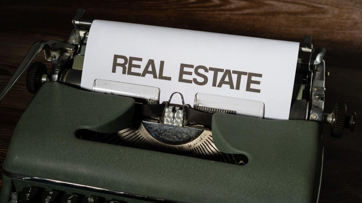 Close-up of a retro typewriter with 'Real Estate' text on paper.