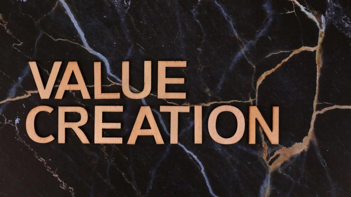 Wooden letters spelling 'Value Creation' on dark marble background, perfect for business themes.