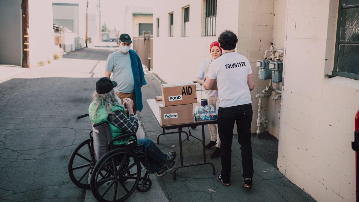 Volunteers distribute food and medicine to those in need, demonstrating compassion and community support.