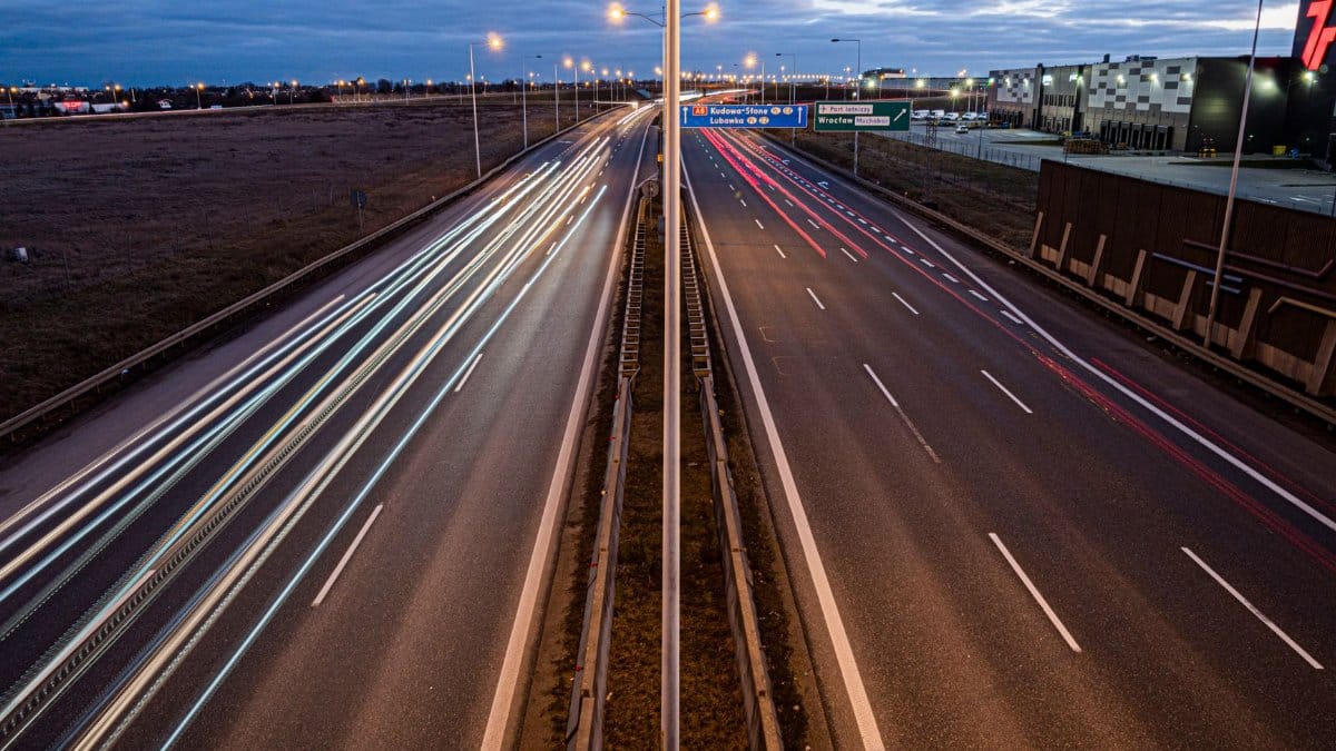 Captivating night view of Wrocław freeway showcasing light trails and urban infrastructure.