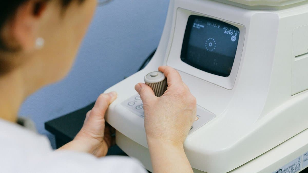 An optometrist operates an eye examination machine in a clinic setting, enhancing visual health care.