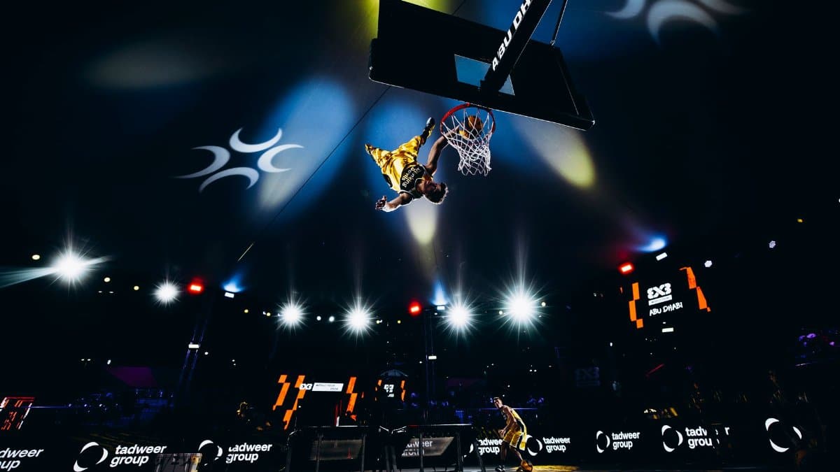 High-energy slam dunk action at a basketball game in Abu Dhabi, UAE.