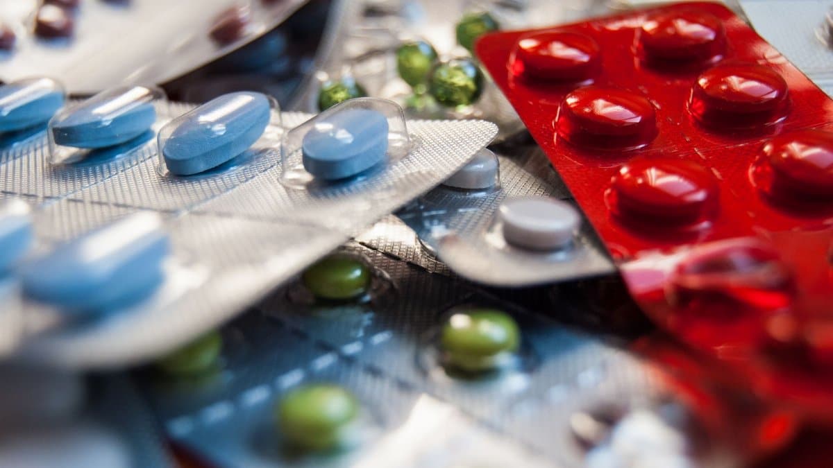 Close-up of various colored medication pills in blister packs.