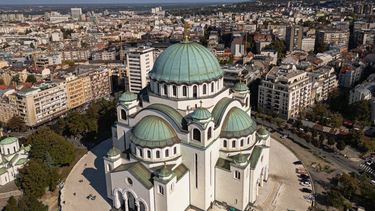 Aerial photography showcasing the grandeur of St. Sava Temple in Belgrade, Serbia against the city's urban landscape.