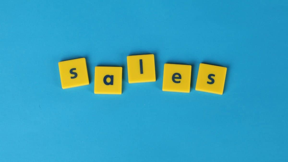 Yellow Scrabble tiles spelling 'sales' on a vibrant blue background. Perfect for marketing and business themes.