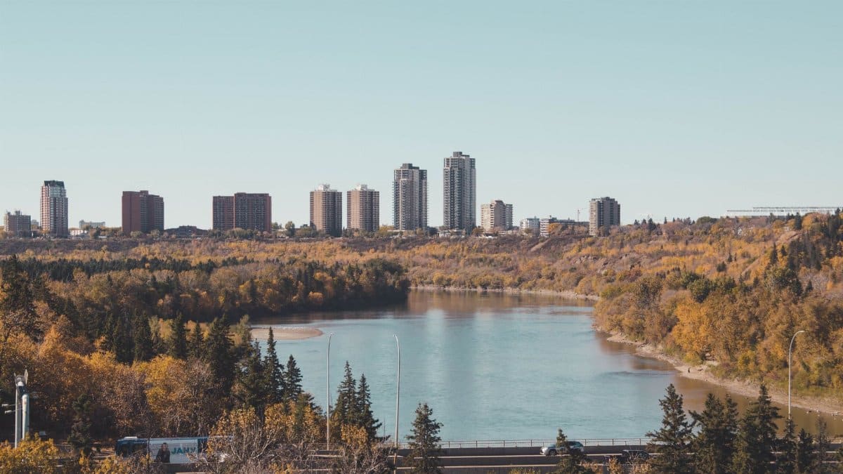 Breathtaking cityscape with a river and fall foliage, perfect autumn travel destination.