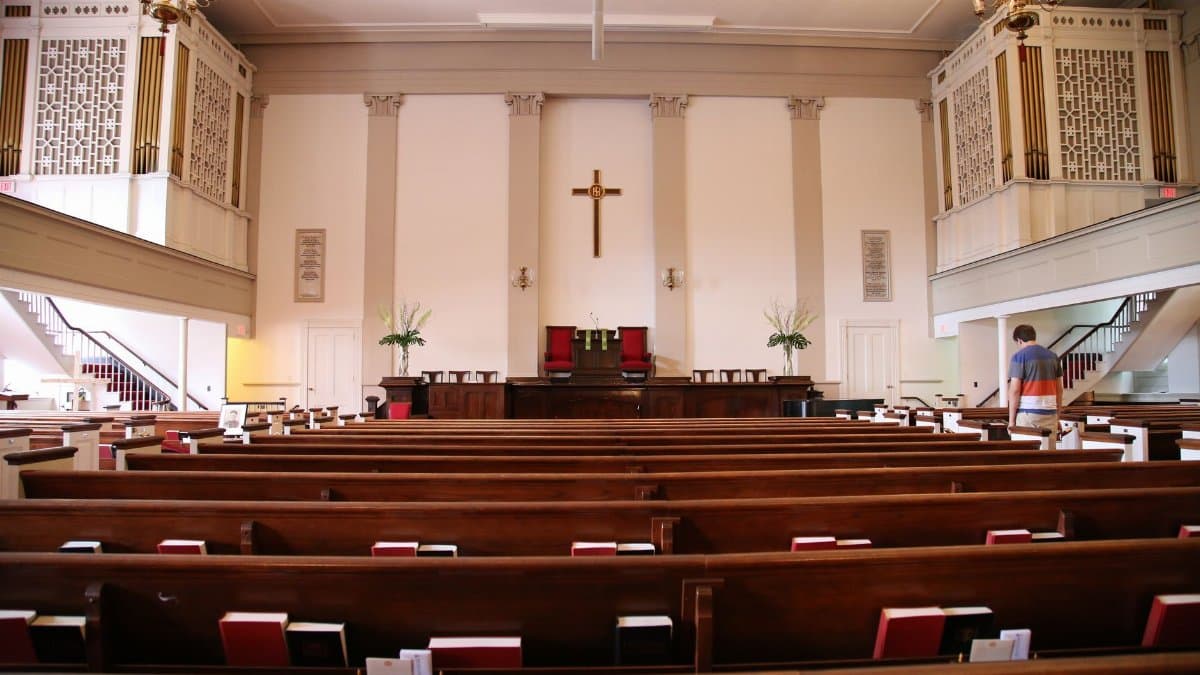 Beautiful interior of a historic church in Boston with wooden benches and altar.