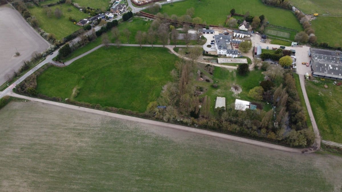 Aerial photo showcasing lush green fields and rural homes in Central Bedfordshire, England.