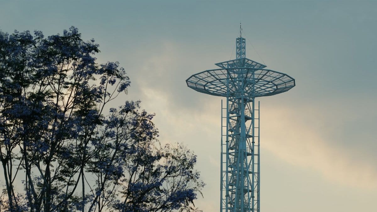 A scenic view of an observation tower with nearby trees during twilight.