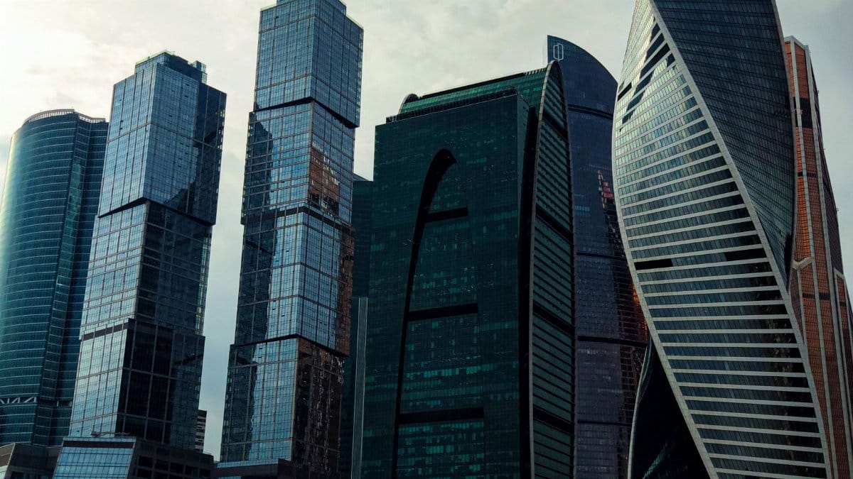 Modern skyscrapers of Moscow City skyline captured under an overcast sky, highlighting architectural design.
