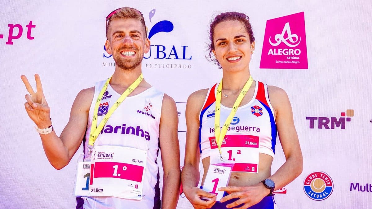 Happy marathon winners celebrating victory at outdoor Setúbal event.
