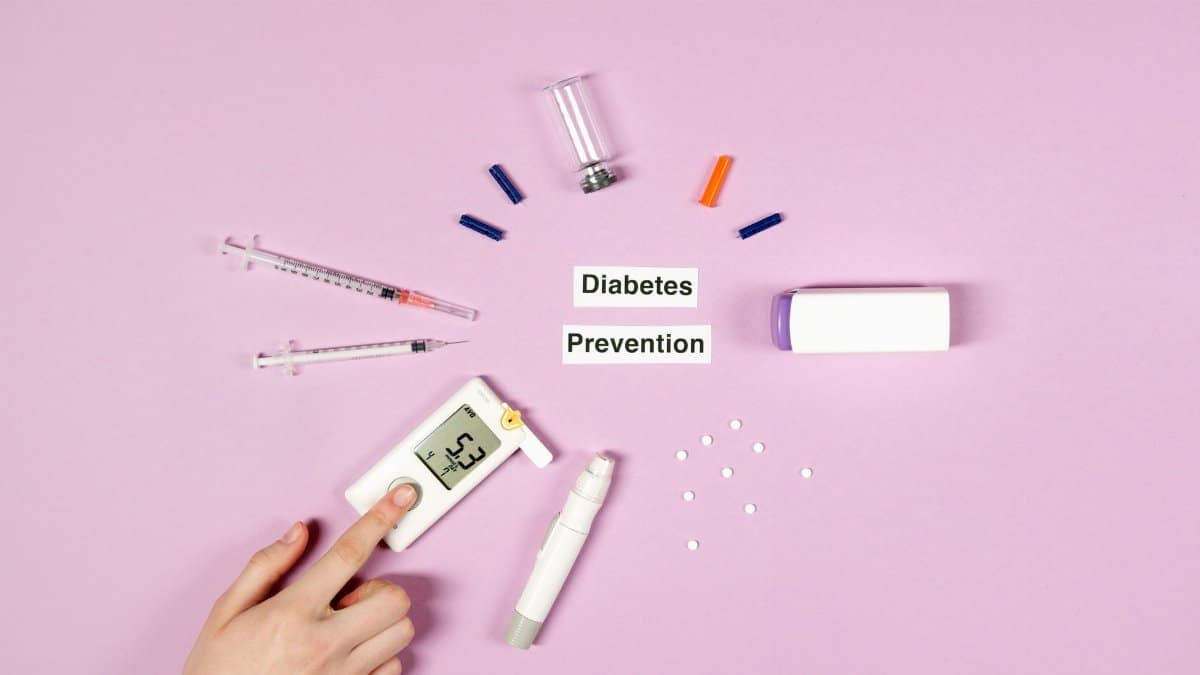 Flat lay of diabetes prevention tools including glucometer on purple background.