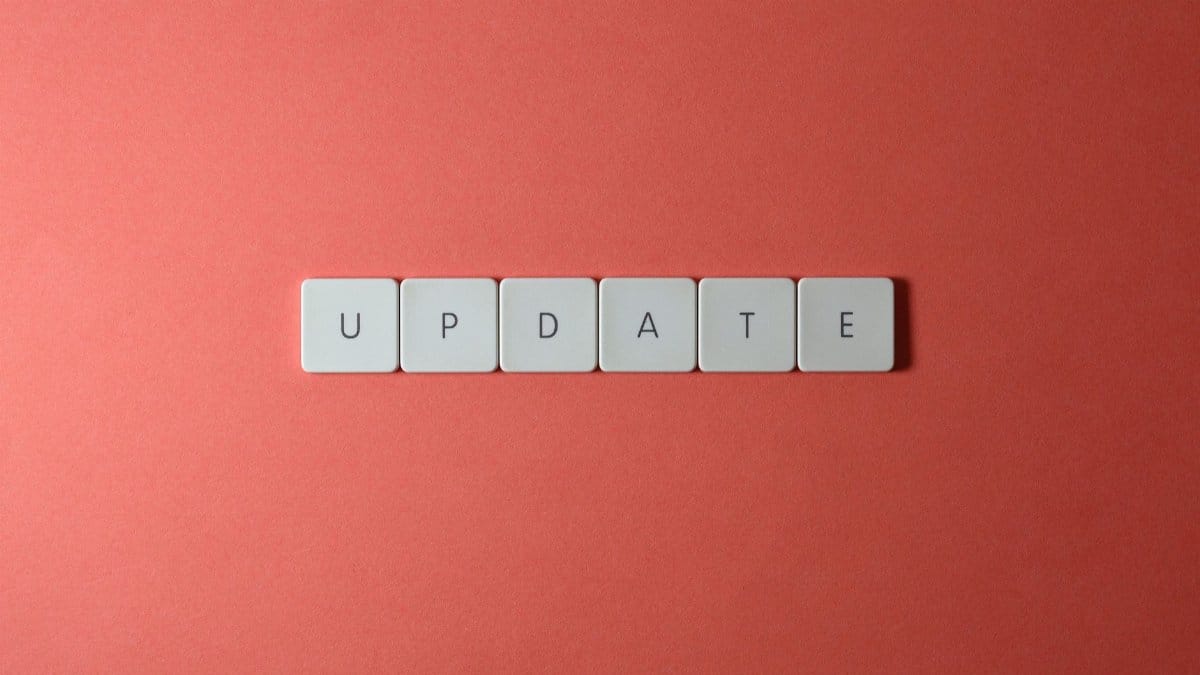 Keyboard keys arranged to spell 'update' on a vibrant red background, ideal for conveying tech concepts.