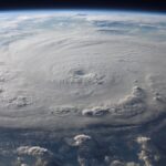 A stunning aerial view of Earth with a massive swirling hurricane, highlighting meteorological beauty.