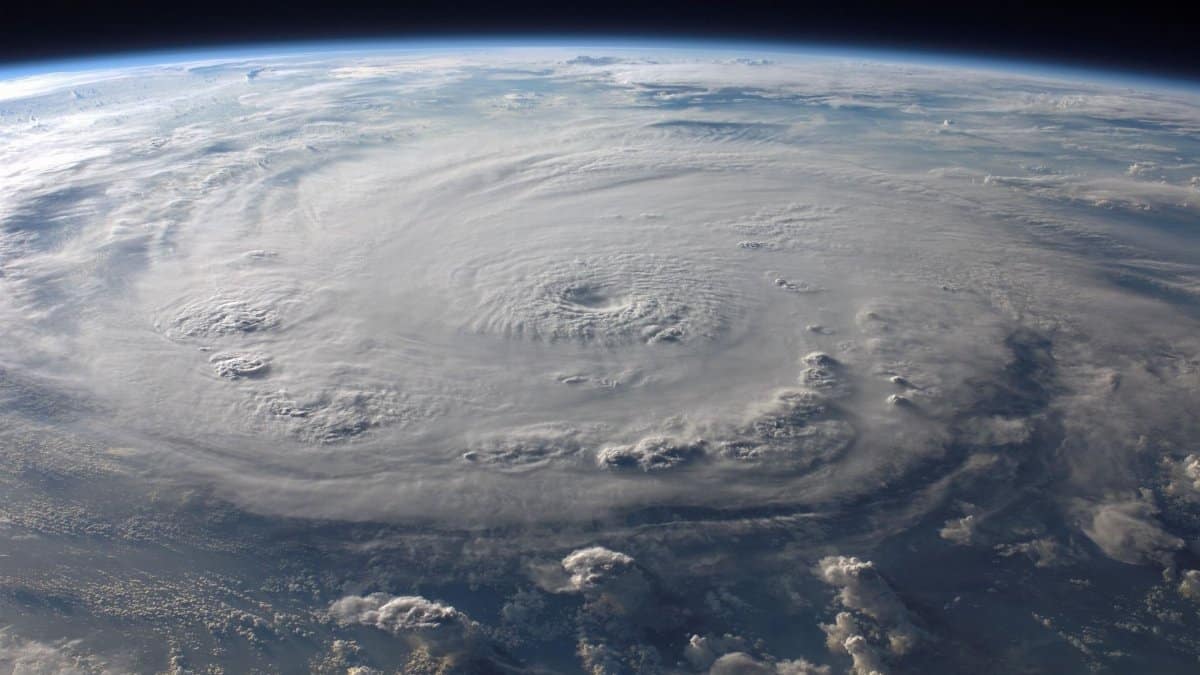 A stunning aerial view of Earth with a massive swirling hurricane, highlighting meteorological beauty.