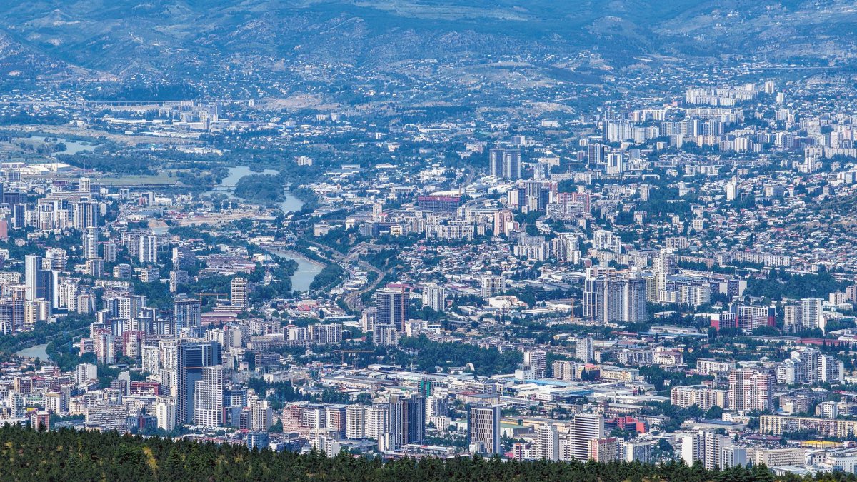 Expansive aerial view capturing the urban sprawl of Tbilisi, Georgia, highlighting modern architecture.