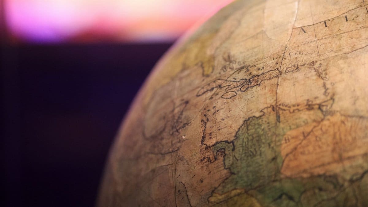 Close-up of a vintage globe with a focus on the North Atlantic Ocean.
