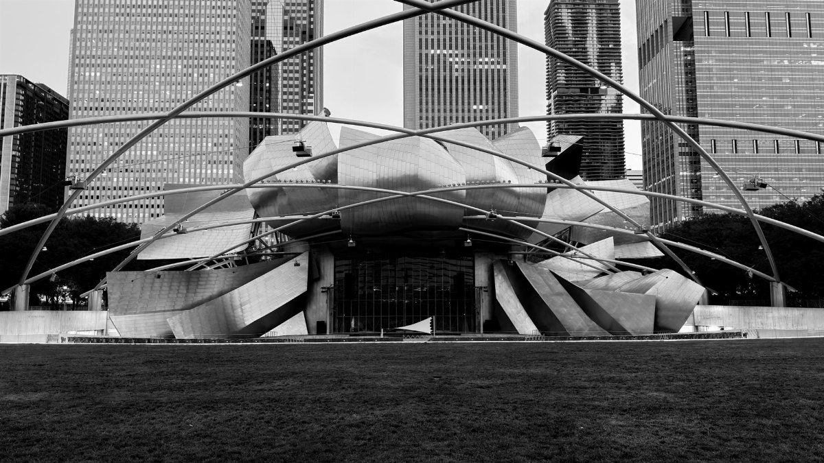 Black and white photo of Jay Pritzker Pavilion, a modern architectural landmark in Chicago.