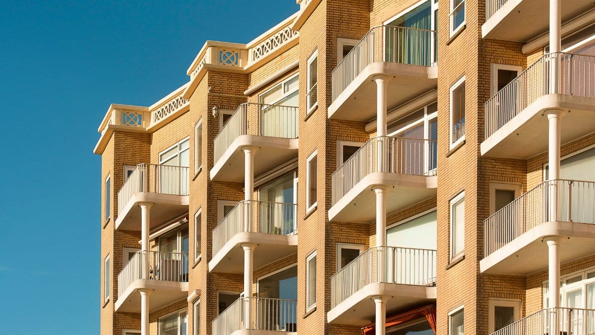 Contemporary apartment building featuring multiple balconies, ideal for urban living environments.
