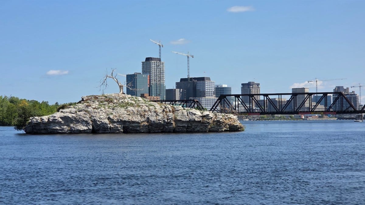 Scenic view of a rocky island and urban skyline in Gatineau, Quebec, Canada.