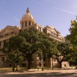 Stunning view of a historic courthouse building with trees, in downtown Houston, Texas.