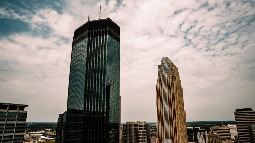 Aerial view of Minneapolis skyscrapers with a partly cloudy sky overhead.