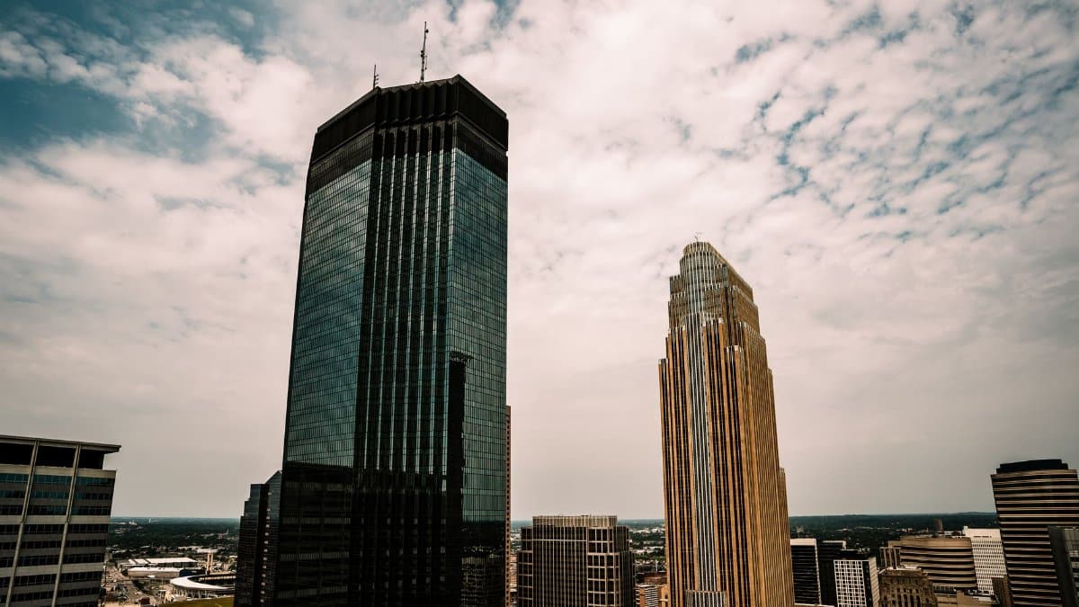 Aerial view of Minneapolis skyscrapers with a partly cloudy sky overhead.