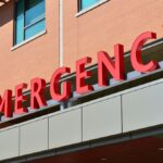 Close-up of a modern hospital emergency room entrance with prominent red letters.